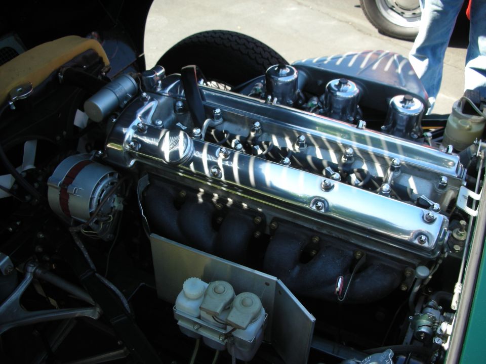 Engine with chrome valve covers and triple carburetors, viewed from the front
