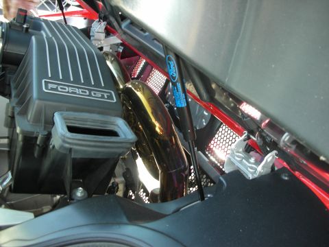 1998 Ford Crown Victoria - Close-up of engine components including an air intake and exhaust pipe.