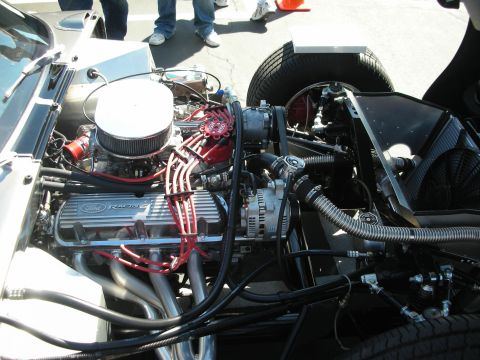 1998 Ford Crown Victoria - Close-up view of a Ford Racing V8 engine, showing chrome headers and red spark plug wires.