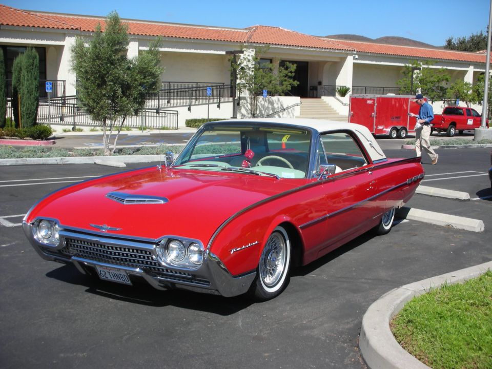 Red 1962 Ford Thunderbird convertible with a white top, front 3/4 view