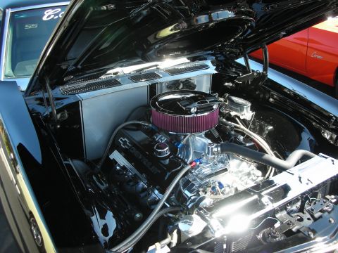 1998 Ford Crown Victoria - Customized Chevrolet engine bay at a car show, with another vehicle in the background.