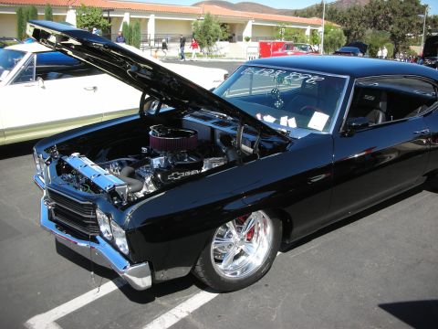 1998 Ford Crown Victoria - A black classic car is displayed with its hood open, revealing the engine bay.