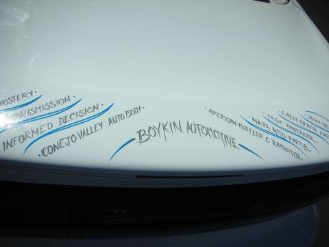 1998 Ford Crown Victoria - White car trunk displays pinstriping and text listing auto services from Boykin Automotive.