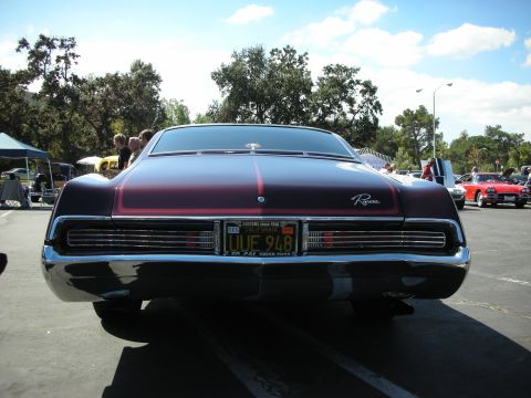1998 Ford Crown Victoria - Rear view of a 1968 Buick Riviera at a car show, its distinctive taillights and chrome trim.