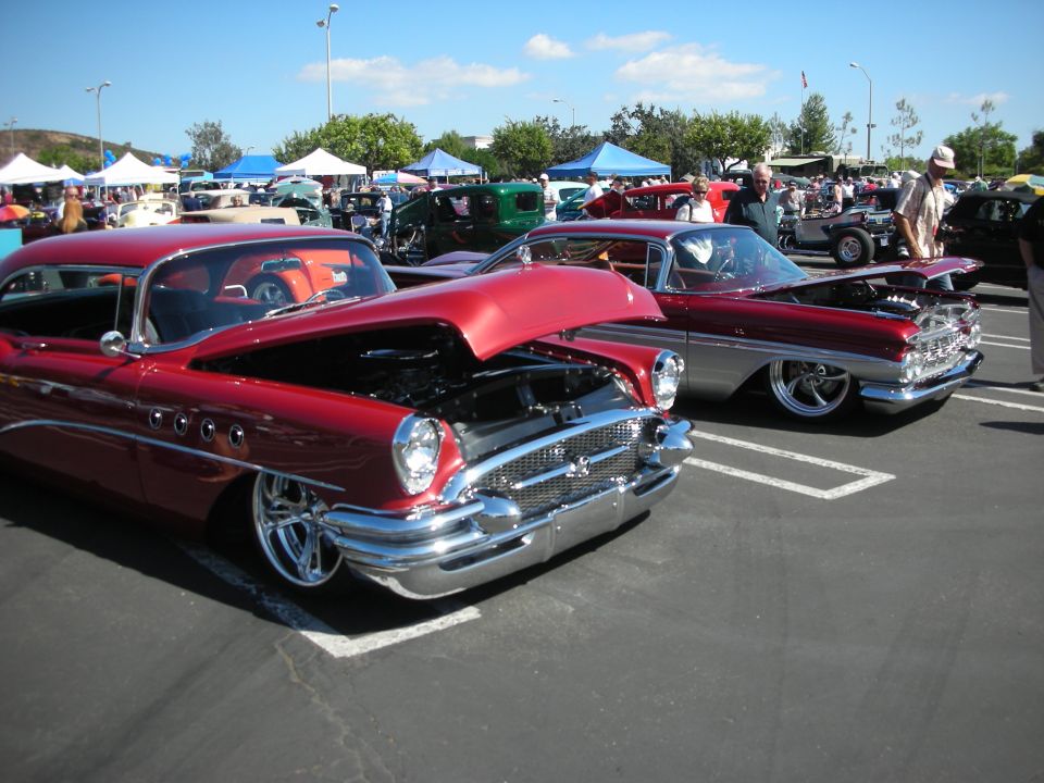 Red classic car front view, hood open, chrome grille, custom wheels