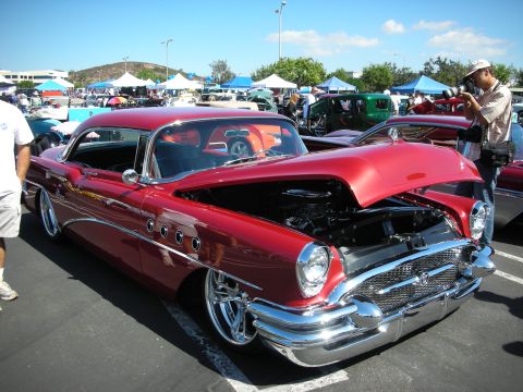 1998 Ford Crown Victoria - Classic 1955 Buick Special on display at a car show, hood raised to reveal the engine.