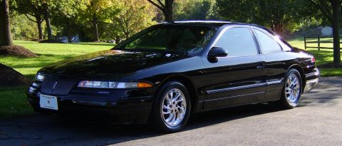 1996 Mercury Grand Marquis - Black coupe with chrome wheels parked outdoors on a sunny day.
