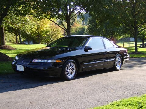 1996 Mercury Grand Marquis - Black 1996 Lincoln Mark VIII coupe with chrome wheels parked outdoors on a sunny day.
