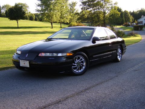 1996 Mercury Grand Marquis - A black Lincoln Mark VIII coupe is shown from a three-quarter front view, chrome wheels and a dark grille.
