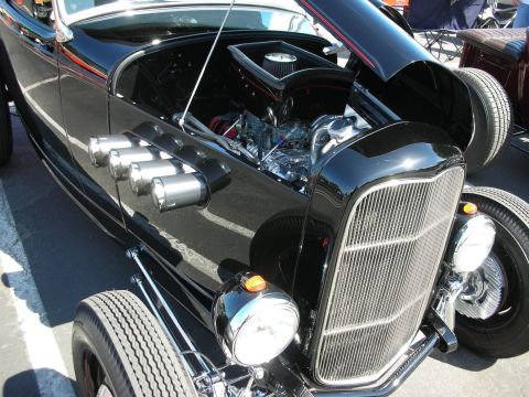 1998 Ford Crown Victoria - A black hot rod with its hood open, revealing the engine and chrome details.