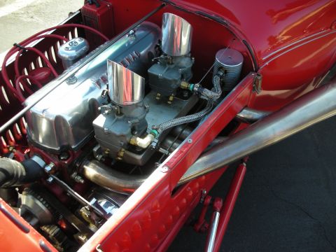 1998 Ford Crown Victoria - The engine compartment of a custom vehicle features a V8 engine with chrome accents and dual carburetors.