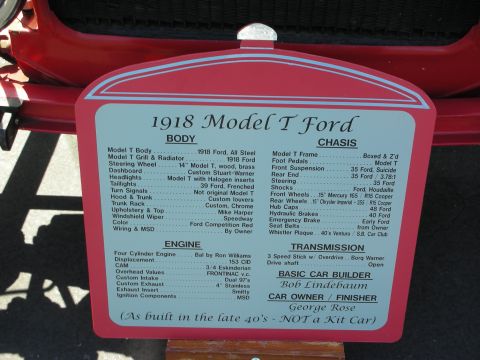 1998 Ford Crown Victoria - A red placard details the specifications of a 1918 Model T Ford, including its body, chassis, and engine components.
