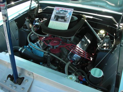 1998 Ford Crown Victoria - A card with a picture of a car sits on the air cleaner in this engine bay.