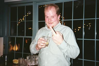 2001 Ford Mustang - A man holds a drink and gestures with his middle finger in front of a window with lights. The Supermotors logo is visible in the lower righ…