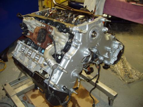 2007 Ford Mustang - Engine assembly displayed on a metal stand, showing intricate mechanical details.