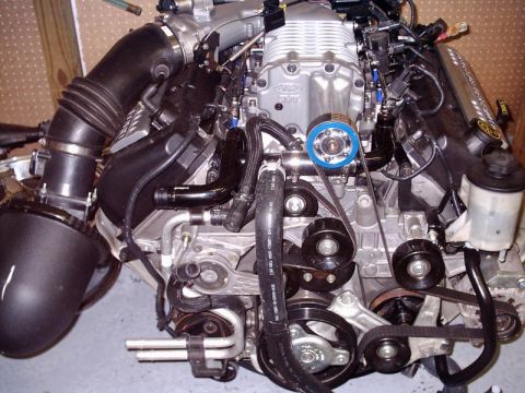 2007 Ford Mustang - Close-up view of a Ford V8 engine assembly, highlighting the supercharger and belt system.