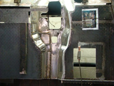 1948 Jeep Wrangler - This image shows extensive body panel repair work on a vehicle, with visible welding and metal patching.