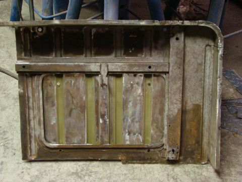 1948 Jeep Wrangler - Close-up of a rusted metal panel, likely a vehicle part, showing internal bracing.