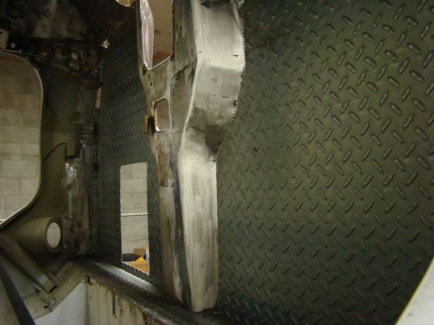 1948 Jeep Wrangler - The interior of a vehicle shows metalwork and diamond plate flooring, indicating repair or customization in progress.