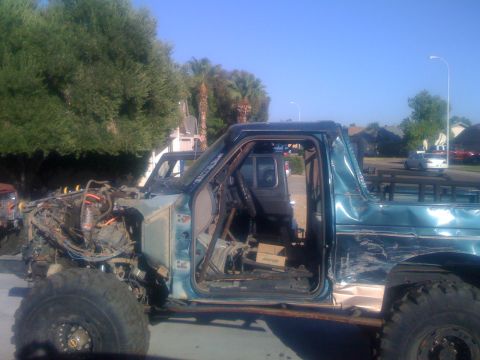 1994 Ford Bronco - This heavily modified SUV is missing its front end and has extensive damage to its side panels.