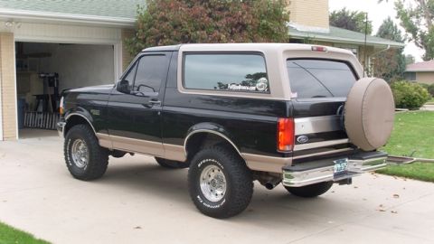 1996 Ford Bronco - This 1996 Ford Bronco has a two-tone black and tan paint scheme and a spare tire mounted on the rear.