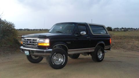 1996 Ford Bronco - This 1996 Ford Bronco features a two-tone black and tan paint scheme and is lifted with off-road tires.