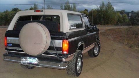 1996 Ford Bronco - This 1992 Ford Bronco is shown from the rear-right angle, with a spare tire mounted on the back.