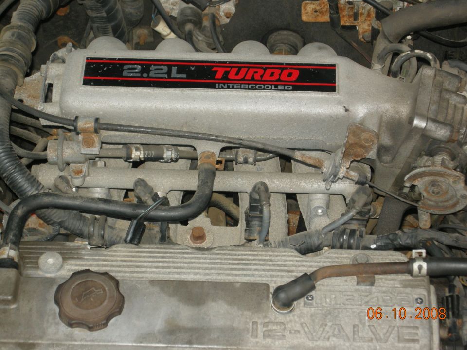 Close-up of a 2.2L Turbo intercooled engine intake manifold with hoses and wires