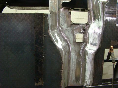 1948 Jeep Wrangler - The raw metal interior of a vehicle shows signs of recent welding and fabrication work.