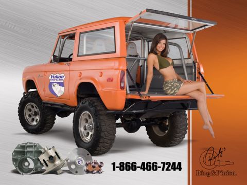 1992 Ford Bronco - Studio calendar-style ad photo of an orange lifted early Ford Bronco in three-quarter rear view, with the tailgate down, rear glass raised,…