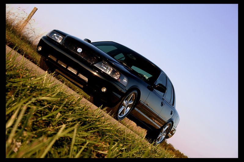 Black 2003 Mercury Marauder parked on a grassy incline