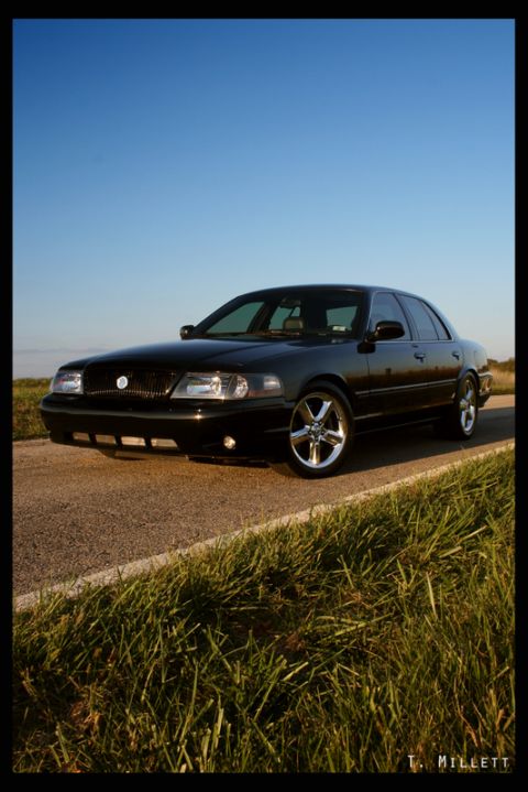 2003 Mercury Marauder - Black 2003 Mercury Marauder parked on a paved road with grass and a clear blue sky.
