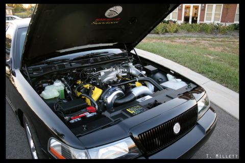 2003 Mercury Marauder - The engine bay of a black 2003 Mercury Marauder is open, revealing a modified engine with a turbocharger.