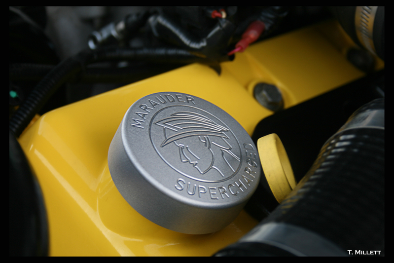 Marauder Supercharged emblem on yellow engine component