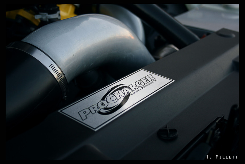 ProCharger intake pipe with hose clamp and ProCharger Technologies Inc. badge