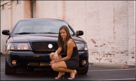 2003 Mercury Marauder - A woman poses in front of a black 2003 Mercury Marauder.