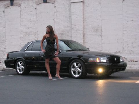 2003 Mercury Marauder - A woman poses next to a black 2003 Mercury Marauder sedan.