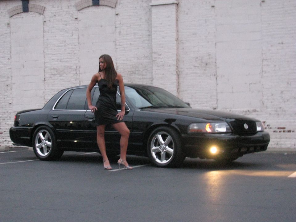 Black 2003 Mercury Marauder with woman, 3q-front view