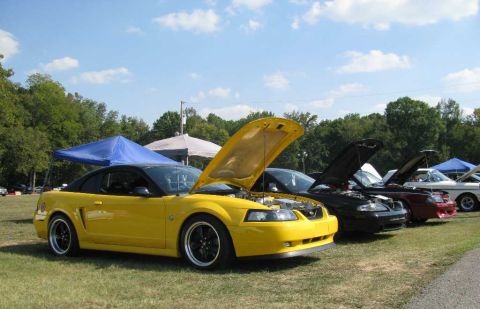 2003 Mercury Marauder - Several cars are parked on a grassy field under a blue tent and a white canopy.