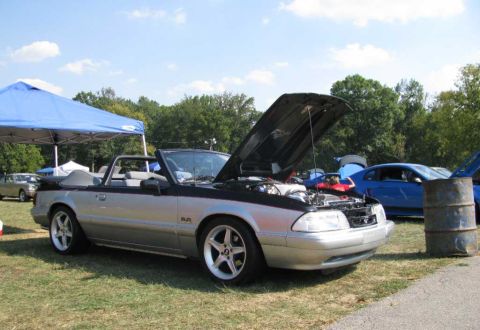 2003 Mercury Marauder - Convertible parked on grass with hood open, other vehicles and a tent in the background.