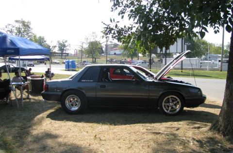 2003 Mercury Marauder - A dark gray Ford Mustang is parked outdoors with its hood open, showing a glimpse of the engine bay.