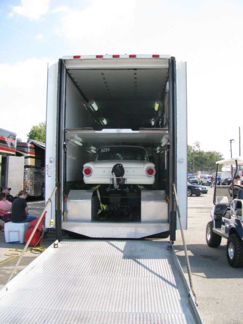 2003 Mercury Marauder - A white drag car is secured inside a trailer, ready for transport to an event.