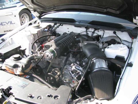 2003 Mercury Marauder - Engine bay view of a modified V8 with a prominent supercharger and custom air intake system.