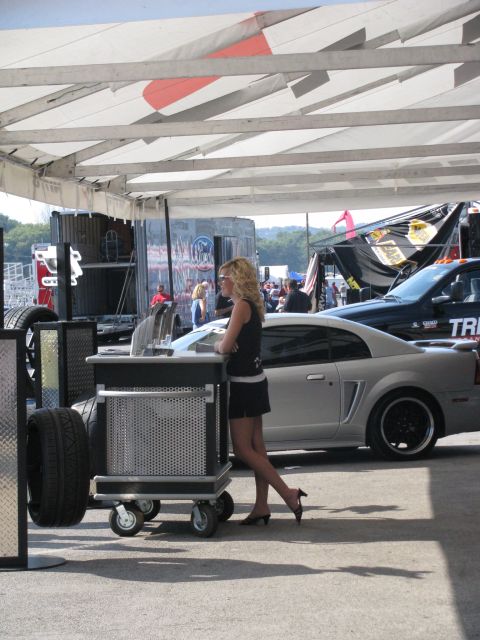 2003 Mercury Marauder - A silver Ford Mustang coupe is parked next to a black truck at an outdoor event.