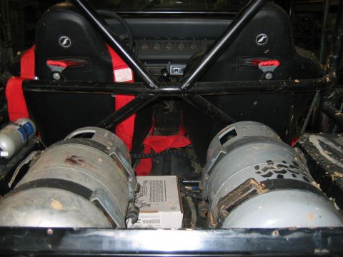1992 Ford Mustang - Modified vehicle interior shows racing seats, roll cage, and two large tanks, possibly for compressed gas.