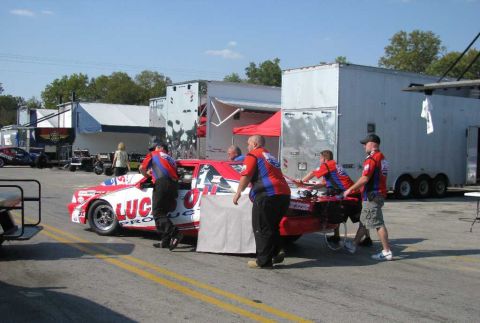 2003 Mercury Marauder - Pit crew members attend to a race car during a break in the action at a racing event.