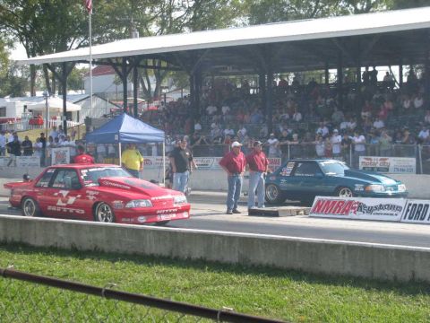 2003 Mercury Marauder - Drag cars prepare for a race at an event with a large crowd watching from the stands.