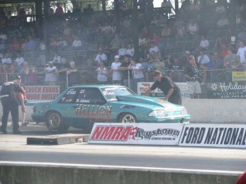 2003 Mercury Marauder - A teal drag car with "HELLION" graphics sits on the track at a drag racing event.