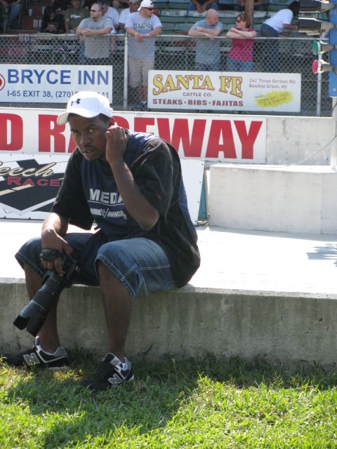 2003 Mercury Marauder - Spectator with camera at a drag strip, with advertising banners in the background.
