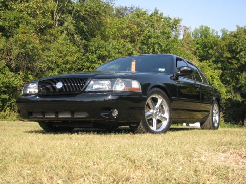 2003 Mercury Marauder - The front 3/4 view of a black 2003 Mercury Marauder shows its distinctive grille and chrome wheels.